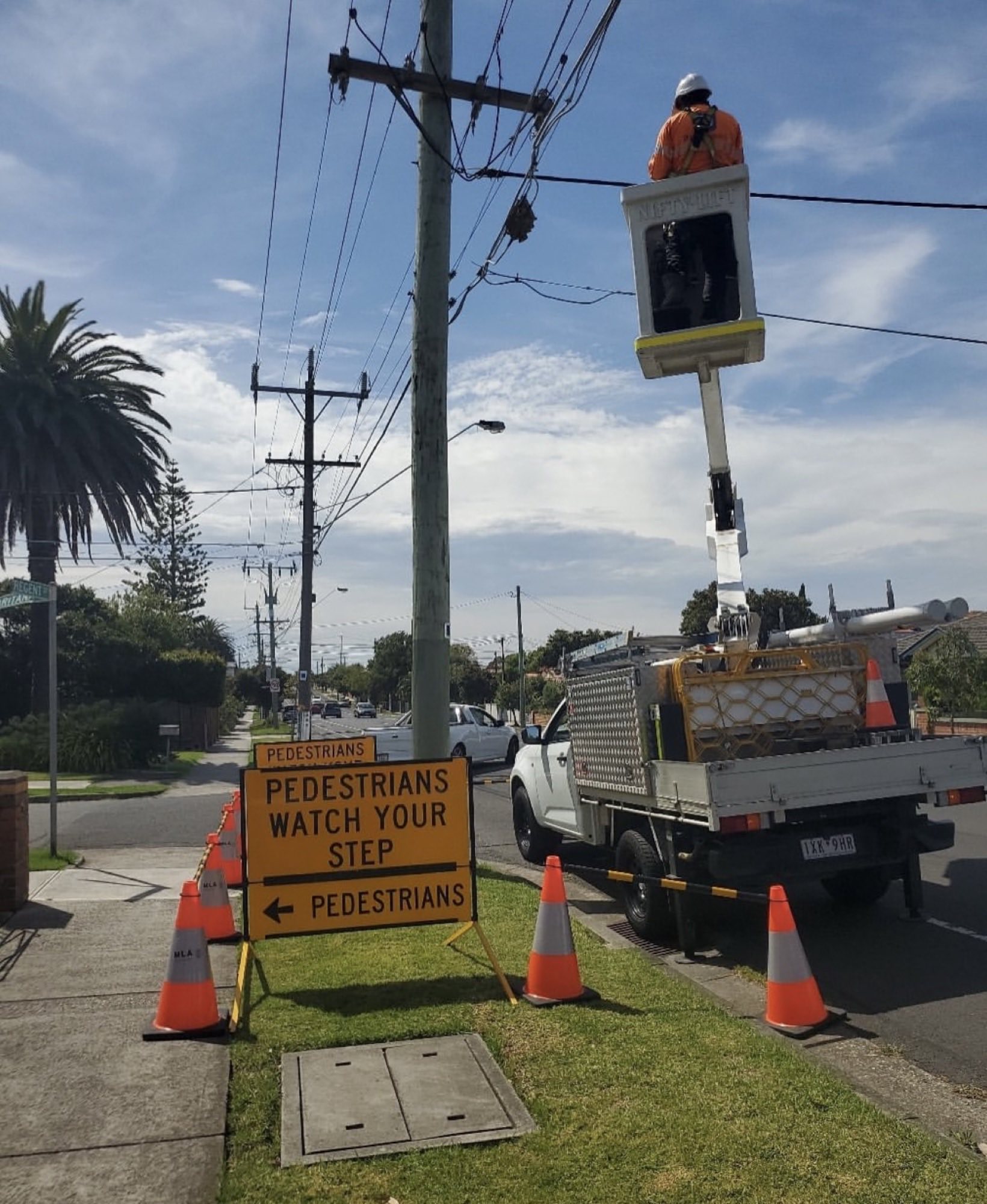 MLA Traffic managing overhead utility works with a cherry picker