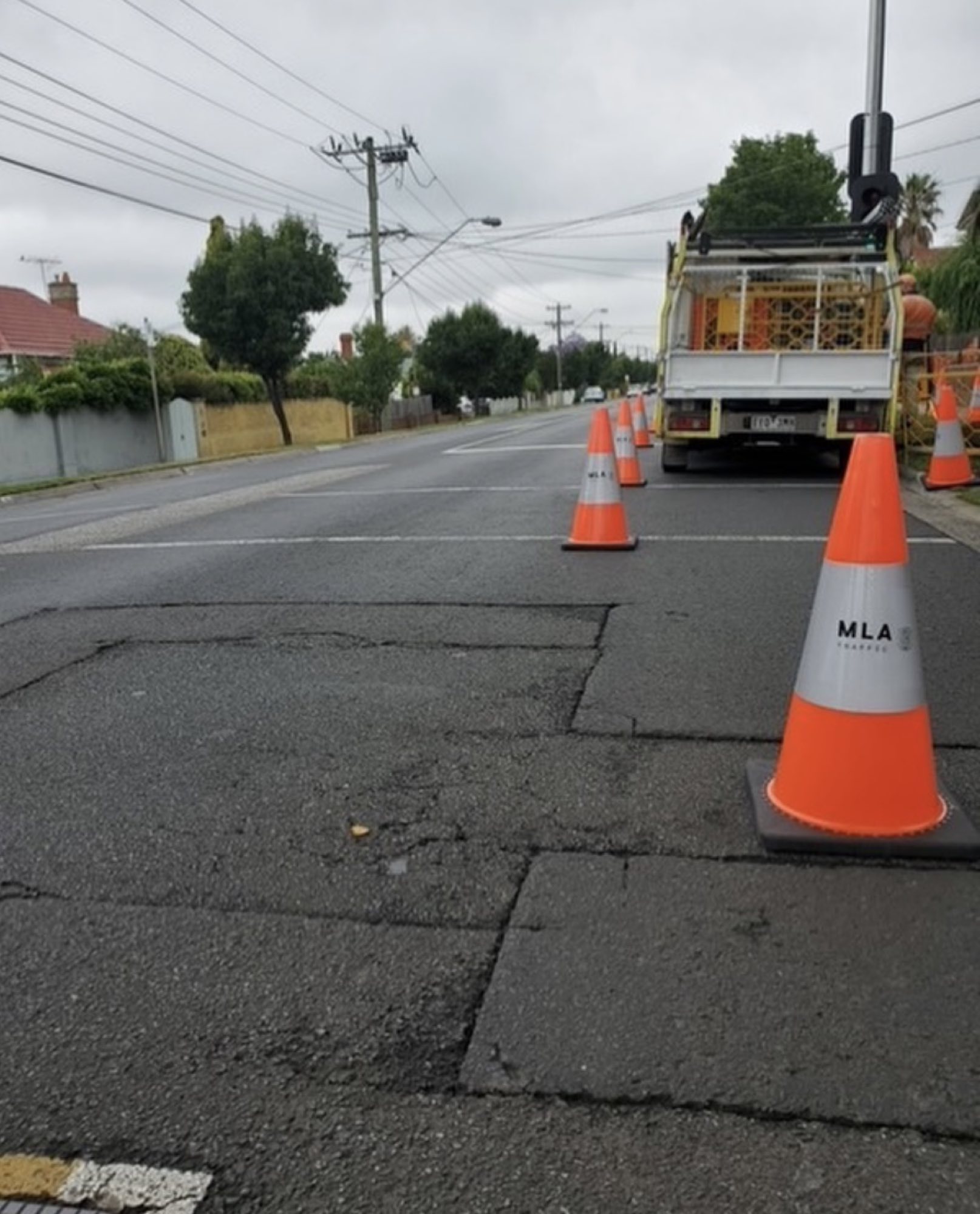 Close-up of an MLA-branded traffic cone on a residential street